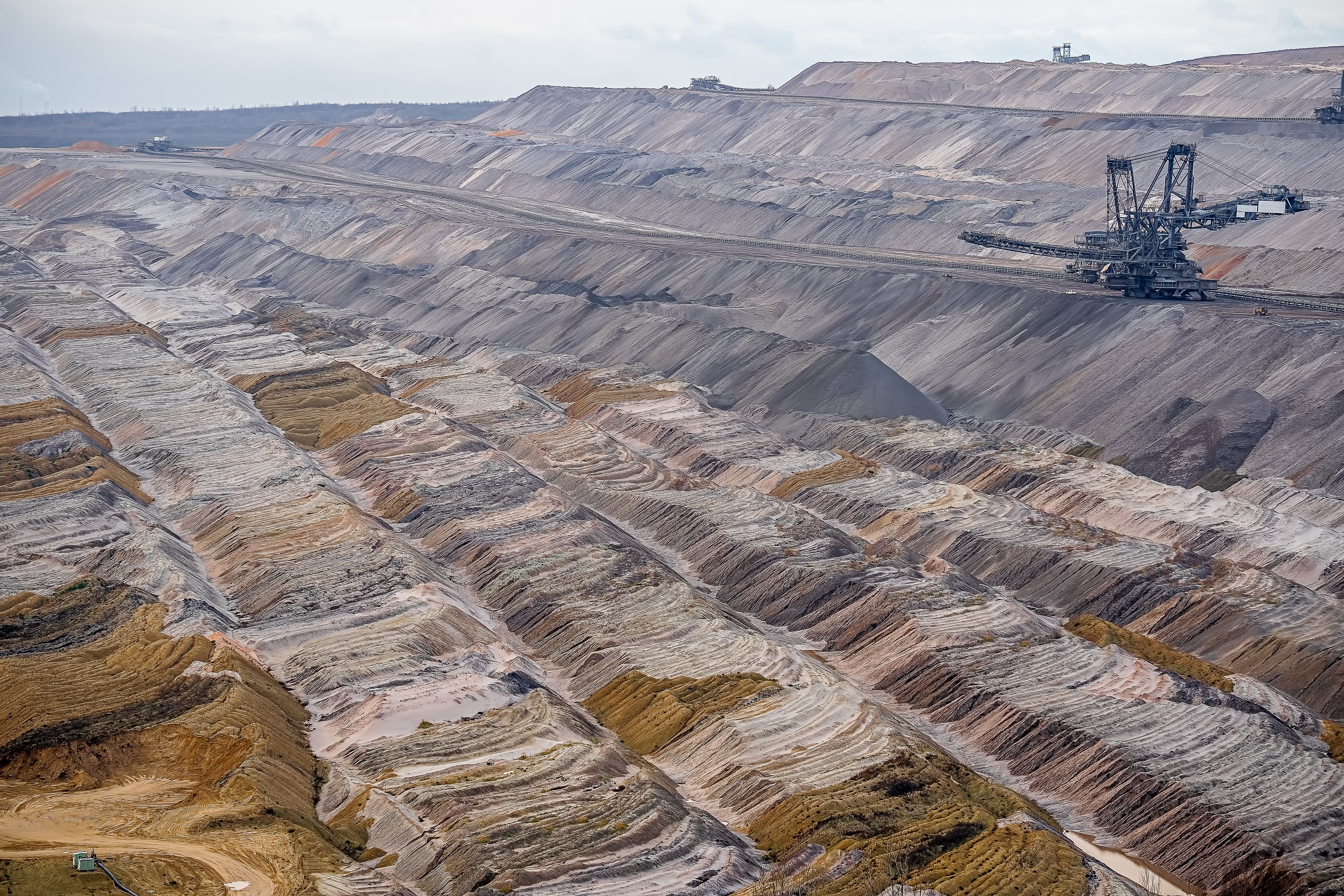 Large open-pit mine showing geological terraces